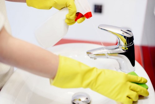 Local technician treating stains on a lounge sofa